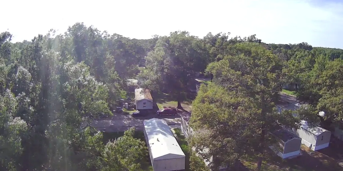 Concrete RV pads at Pecanland Mobile Home Park with mix of permanent mobile homes and travel trailers, situated near...