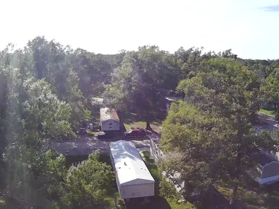 Concrete RV pads at Pecanland Mobile Home Park with mix of permanent mobile homes and travel trailers, situated near...