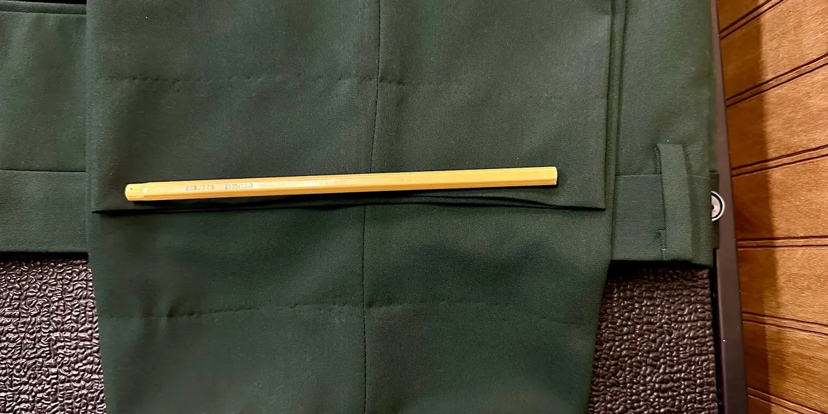 Upscale men's clothing store with neatly arranged suits, vibrant color combinations, and formal wear displays in a...