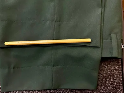 Upscale men's clothing store with neatly arranged suits, vibrant color combinations, and formal wear displays in a...