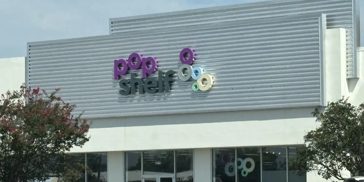 Bright, organized variety store with neatly arranged aisles showcasing colorful seasonal decorations, beauty products,...