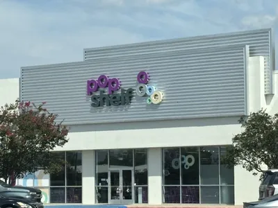 Bright, organized variety store with neatly arranged aisles showcasing colorful seasonal decorations, beauty products,...