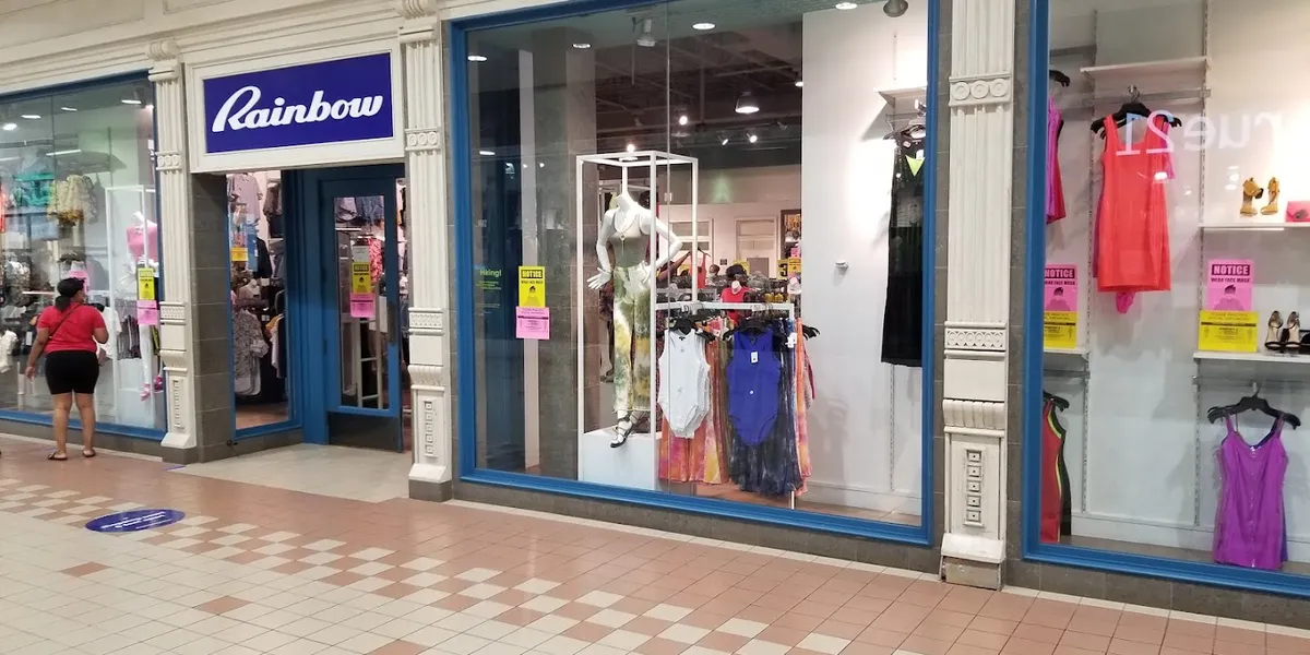 Neatly organized women's clothing displays in Rainbow Shops' Monroe location, showcasing fashion items in a clean but...