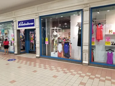 Neatly organized women's clothing displays in Rainbow Shops' Monroe location, showcasing fashion items in a clean but...
