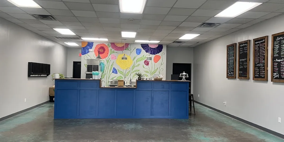 Bright counter-service tea shop with standing room only, featuring colorful drink displays and a casual grab-and-go...