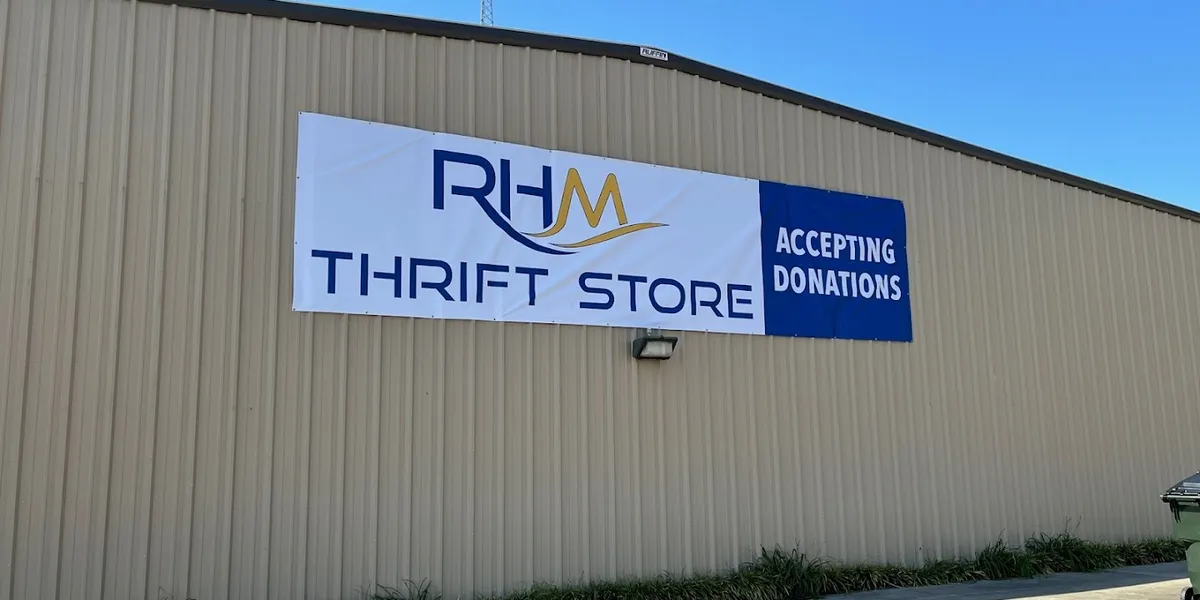 Spacious, well-organized thrift store with neatly arranged merchandise, clean aisles, and a bright, welcoming Christian...