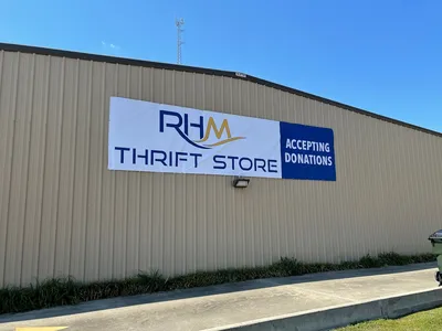 Spacious, well-organized thrift store with neatly arranged merchandise, clean aisles, and a bright, welcoming Christian...