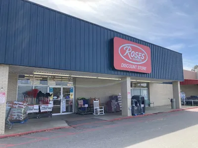 Compact discount store with narrow aisles displaying various merchandise at budget prices, creating a small-scale...