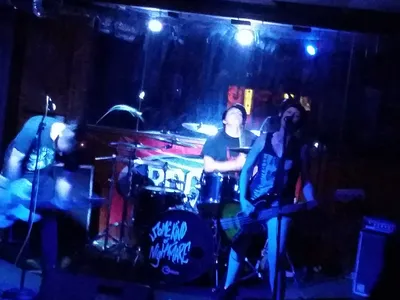 Dimly lit interior of Sal's Saloon showing pool tables, bar counter, and vintage decor creating a classic dive bar...