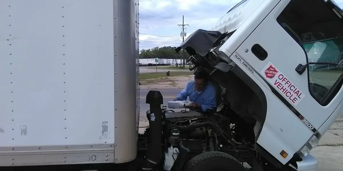 Modest thrift store with varied inventory displays, featuring affordable household items and books arranged in browsable...