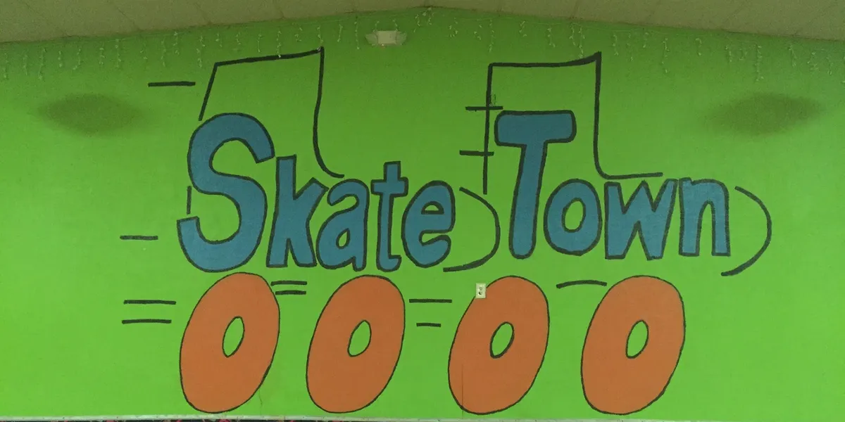 Spacious roller skating rink with polished floors and colorful lighting where families glide alongside children enjoying...