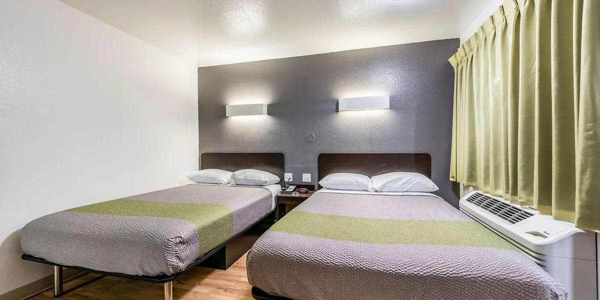 Exterior view of Studio 6 Monroe showing the building entrance with parking lot, located on Martin Luther King Junior Drive.