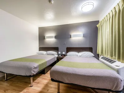 Exterior view of Studio 6 Monroe showing the building entrance with parking lot, located on Martin Luther King Junior Drive.