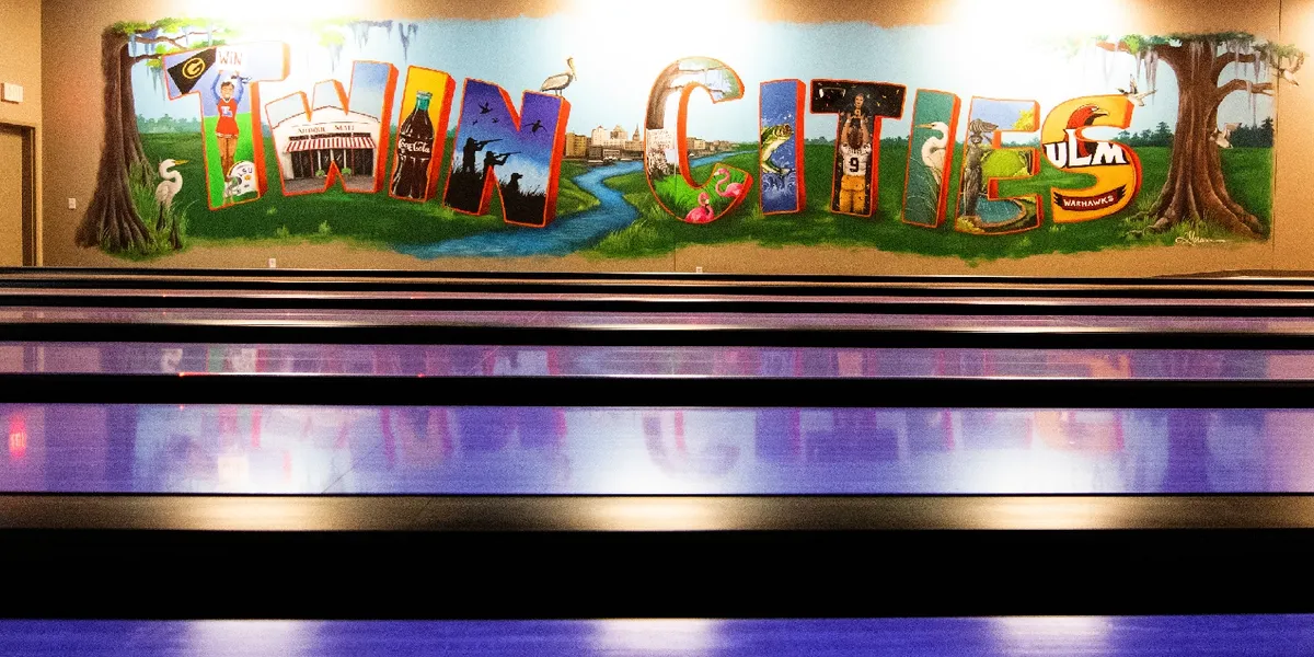 Spacious indoor entertainment complex with colorful obstacle courses, bowling lanes, and play areas filled with active...