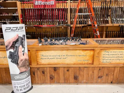 Traditional sporting goods store with hardware section and gun counter, featuring wooden displays and a classic...