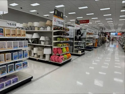 Spacious Target department store with red shopping carts, bright overhead lighting, and organized aisles featuring...