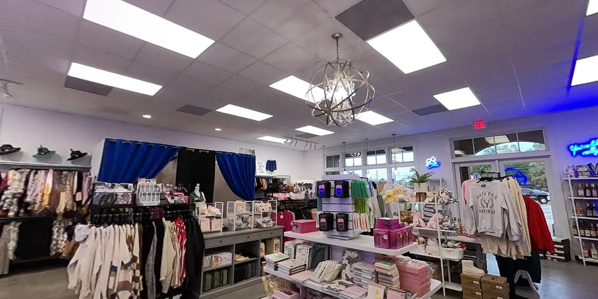 Bright, well-organized clothing boutique with trendy apparel displays, unique accessories, and a clean, modern shopping...