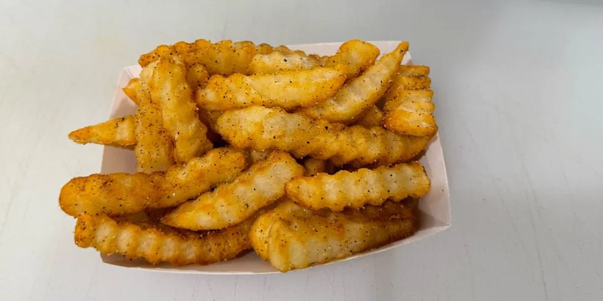 Compact, nostalgic American diner with counter service and simple seating, showcasing homestyle plate lunches in a...