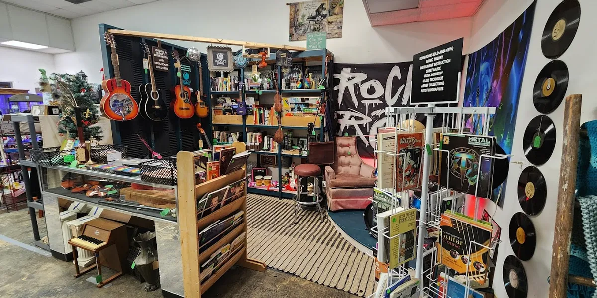 Sprawling indoor flea market with dozens of vendor booths displaying collectibles, furniture, and vintage items in a...