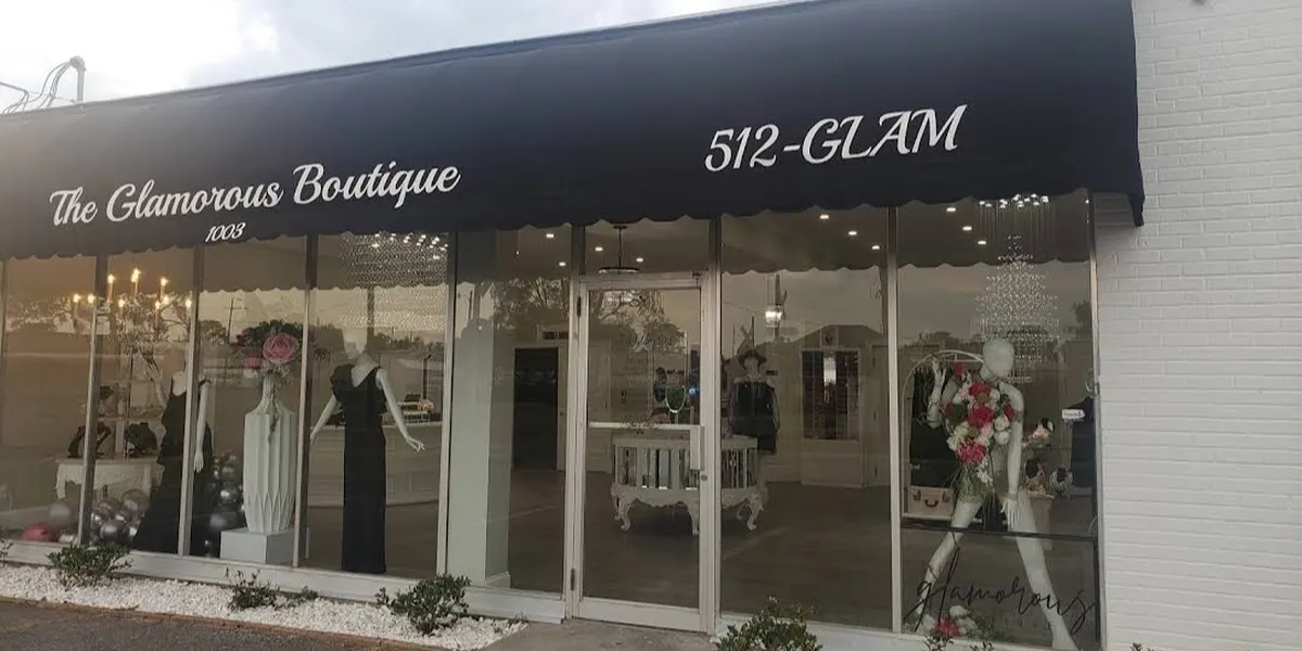 Spacious boutique with elegant displays of trendy clothing and accessories, featuring Louis Vuitton items and a dedicated...