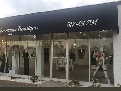 Spacious boutique with elegant displays of trendy clothing and accessories, featuring Louis Vuitton items and a dedicated...