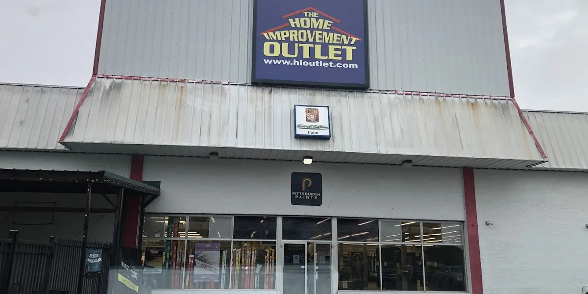 Comprehensive home improvement warehouse with organized lumber selection, diverse building materials, and staff assisting...