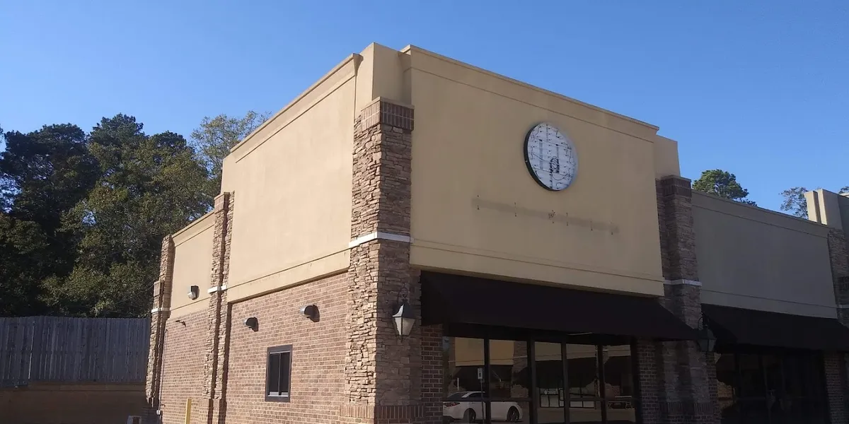 Bright, inviting ice cream counter showcasing homemade flavors with bubble waffle cones and sandwich prep area in a...