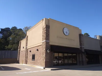 Bright, inviting ice cream counter showcasing homemade flavors with bubble waffle cones and sandwich prep area in a...