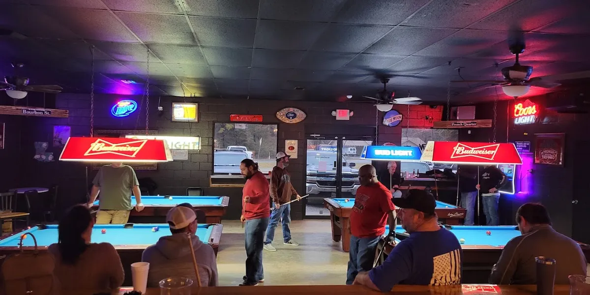 Cozy bar interior with pool tables, bar seating, and space for live music performances in a clean, inviting West Monroe...