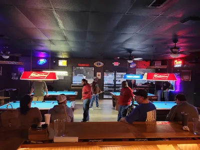 Cozy bar interior with pool tables, bar seating, and space for live music performances in a clean, inviting West Monroe...