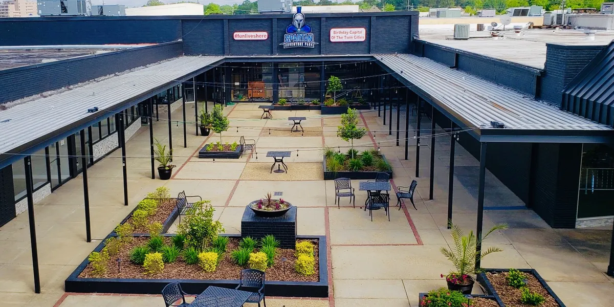 Exterior view of Twin City Shopping Center on Louisville Avenue showing a clean, accessible neighborhood mall with ample...