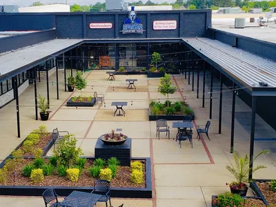 Exterior view of Twin City Shopping Center on Louisville Avenue showing a clean, accessible neighborhood mall with ample...