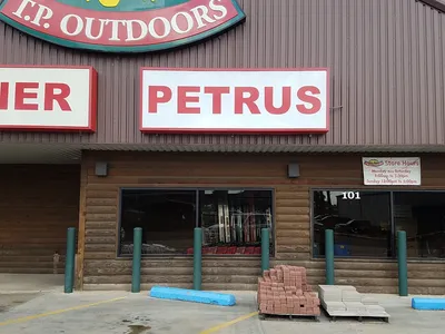 Organized aisles of a traditional hardware store with neatly arranged tools, home supplies, and sporting goods in a...