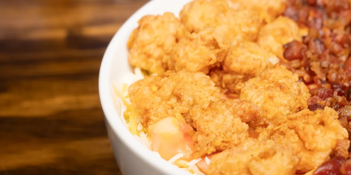 Dimly lit lounge with DJ booth, standalone pool table, bar area serving drinks, and outdoor seating space on Desiard...