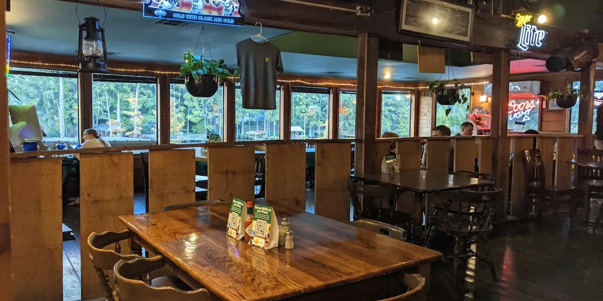 Waterfront restaurant with bayou views, outdoor patio seating, and walls adorned with local historical memorabilia...