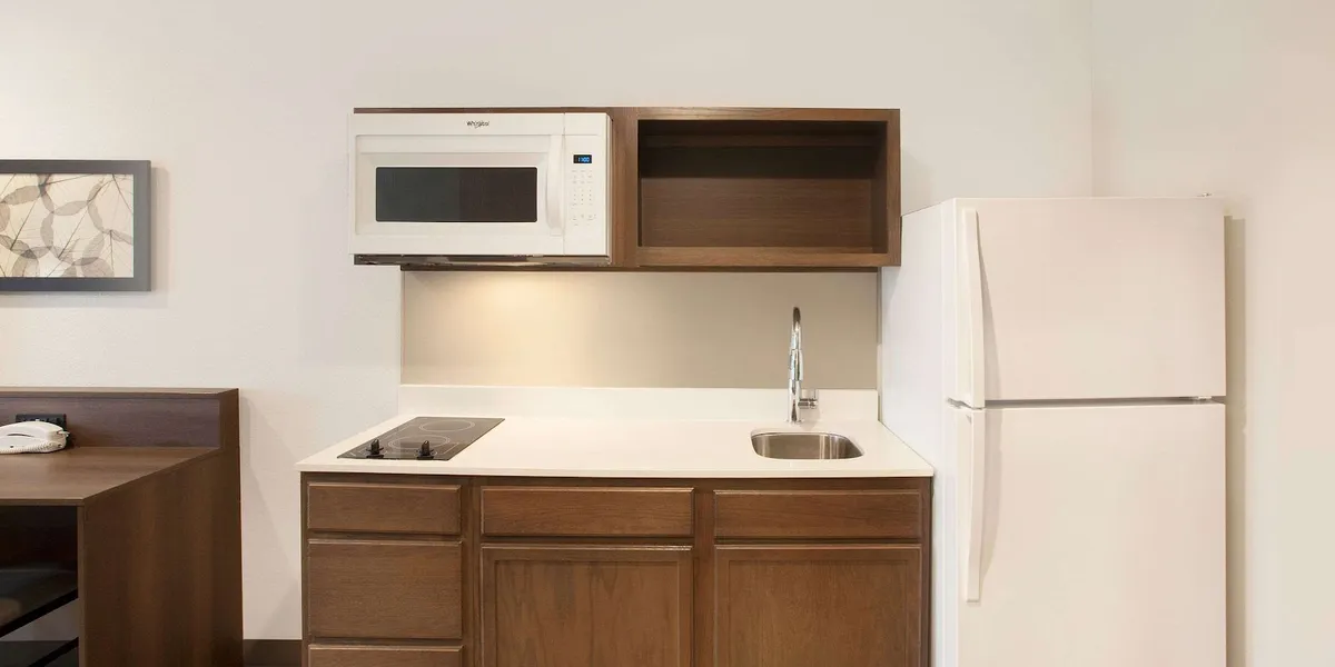 Simple extended stay hotel exterior with parking lot, featuring basic accommodations in a quiet location near I-20 in...