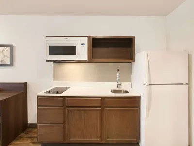 Simple extended stay hotel exterior with parking lot, featuring basic accommodations in a quiet location near I-20 in...