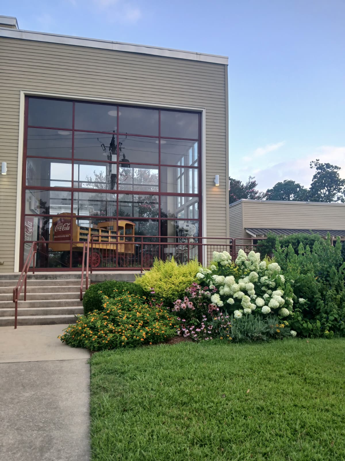 Coca-Cola Museum building at the Biedenharn Museum Monroe Louisiana with yellow delivery truck visible through glass windows