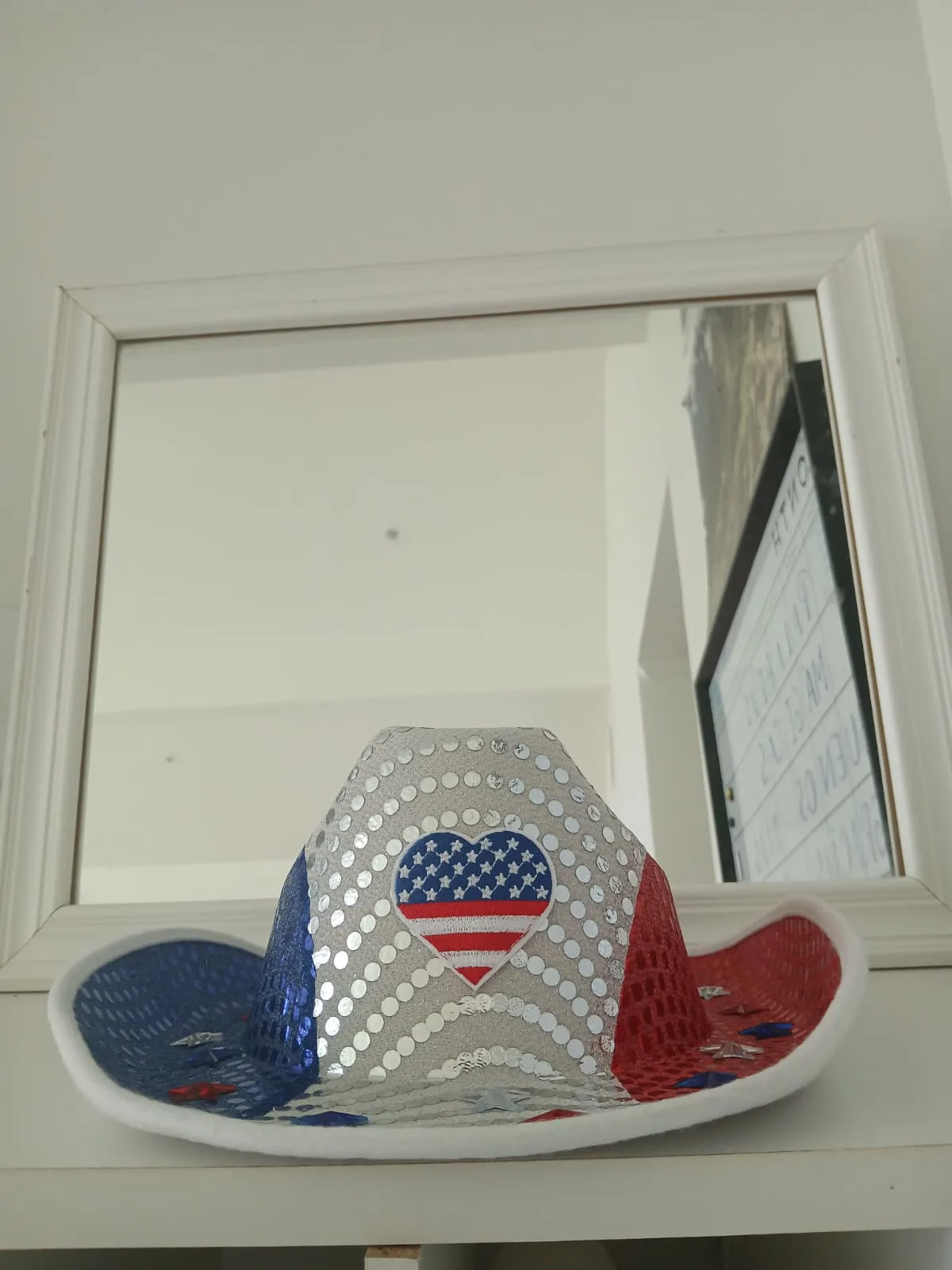 Patriotic cowboy hat in red, white and blue with sequins and an American flag heart, caught at the Twin Cities 250th Anniversary Parade in Monroe