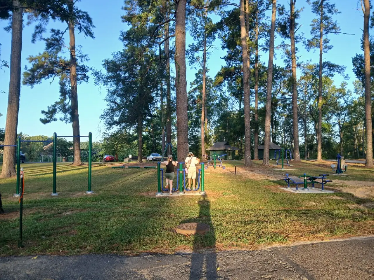 Two people using the new outdoor fitness equipment at Kiroli Park.
