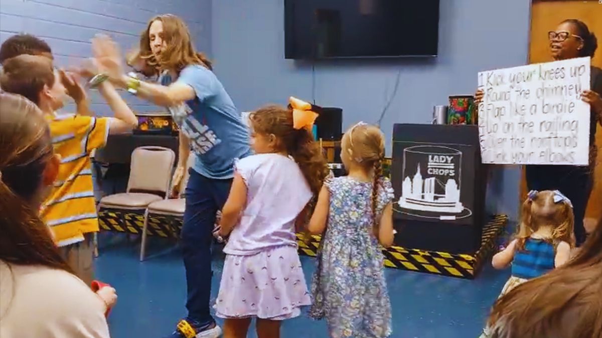 Lady Chops leading Step in Time with kids at Sterlington Library Monroe Louisiana, sign with the six dance moves visible