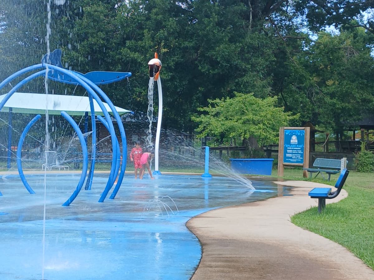 Splash pad at Louisiana Purchase Gardens and Zoo with blue water features and families playing in summer