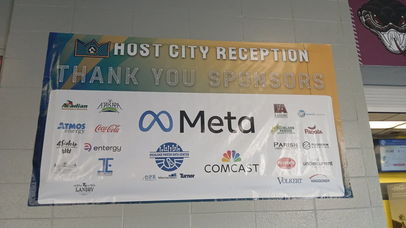 A banner at the Monroe Civic Center thanking sponsors for a host city reception.