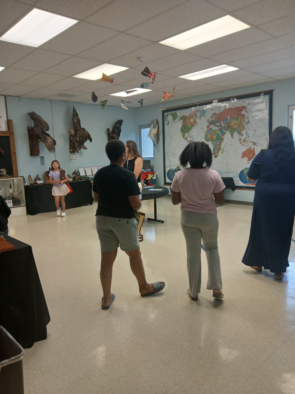 Mystery Monday event room at ULM Museum of Natural History with mounted birds and world map