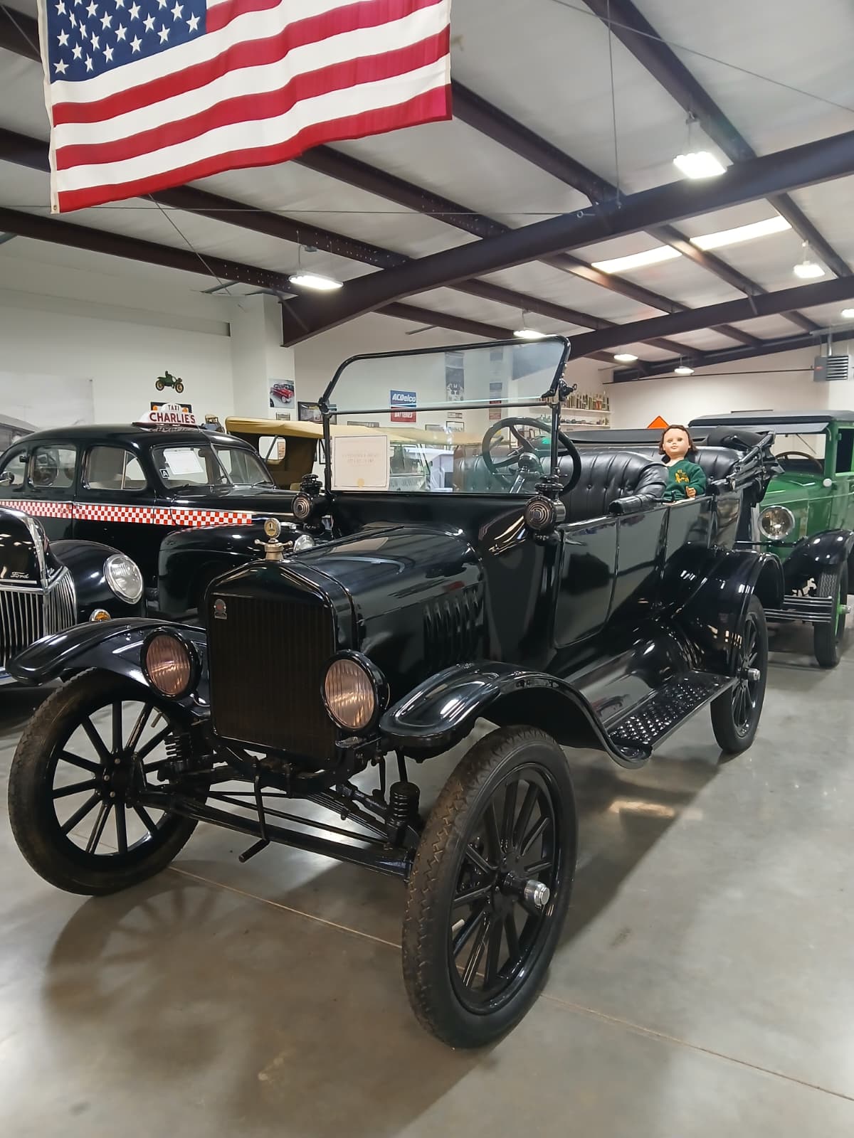 Model T Ford at Vintage Vehicles West Monroe Louisiana with American flag and vintage vehicles in background